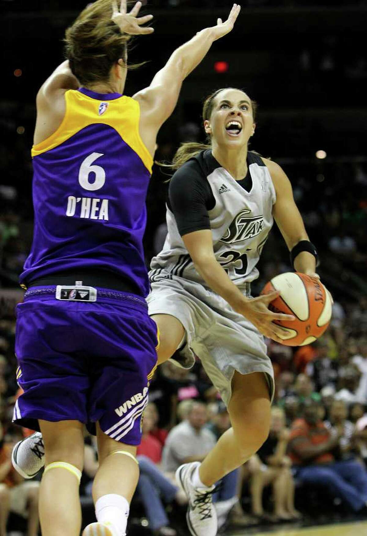 Silver Stars' Becky Hammon (right) goes to the basket against Los Angeles Sparks' Jenna O'Hea (06) in the second half at the AT&T Center on Friday, June 24, 2011. Hammon scored 22 points as the Silver Stars defeated the Sparks, 90-80, in overtime. Kin Man Hui/kmhui@express-news.net