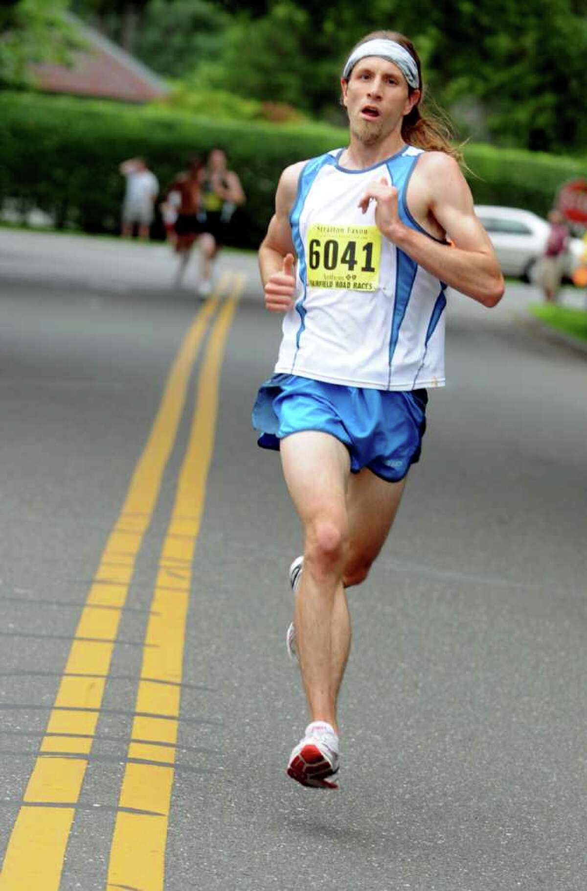 Timothy Milenkevich, of Ansonia, maintains the lead Saturday, June 25, 2011 during the Stratton Faxon 5K through Fairfield, Conn. Milenkevich finished the race in 16:07.