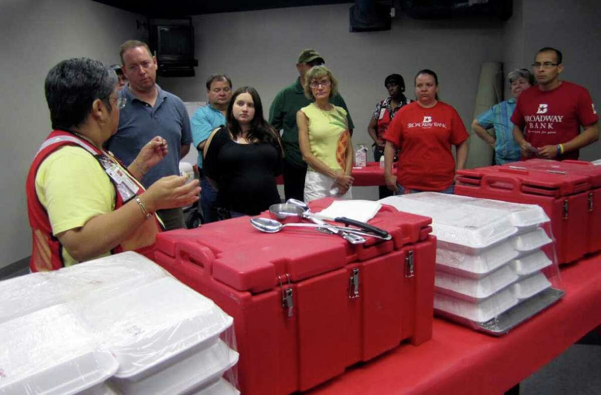 Red Cross volunteer Mary Duclos, left, instructs other volunteers Saturday June 25, 2011 at the Red Cross headquarters on East Houston Street on how to properly handle food at a mass care shelter that would be established after a disaster.