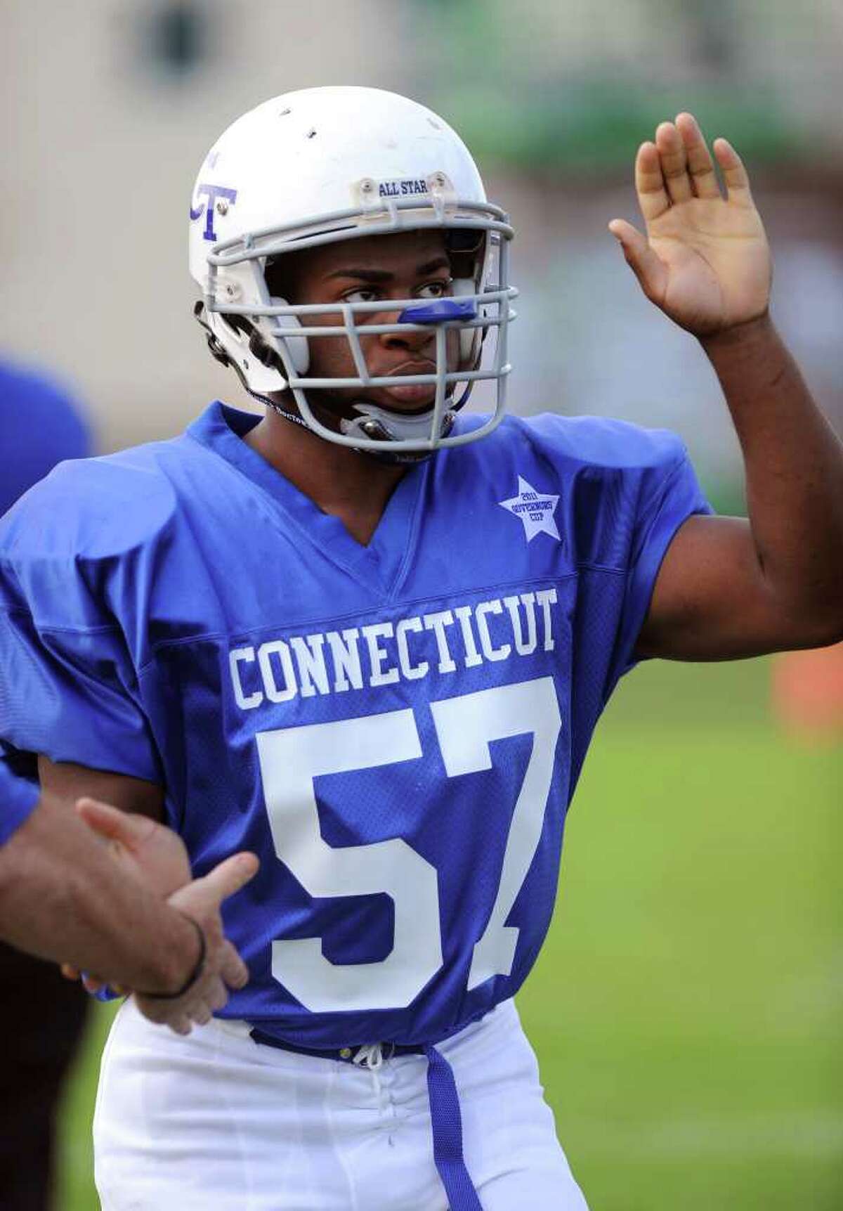 Stamford High School's Mark Robinson enters the field for the Connecticut High School football all-star game against Rhode Island on June 25, 2011, at Southington High School.