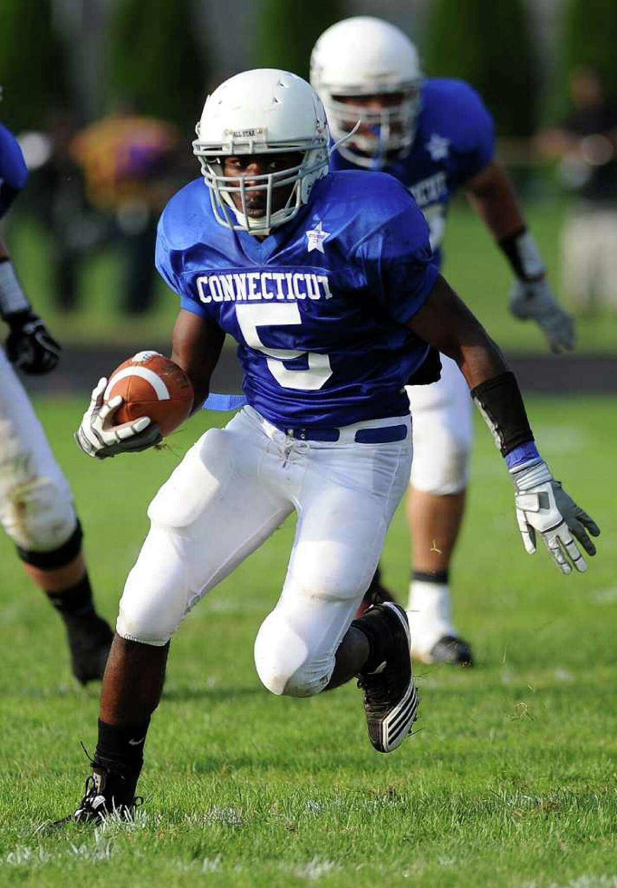 Ansonia High School's Montrell Dobbs carries the ball during the Connecticut High School football all-star game against Rhode Island on June 25, 2011, at Southington High School.