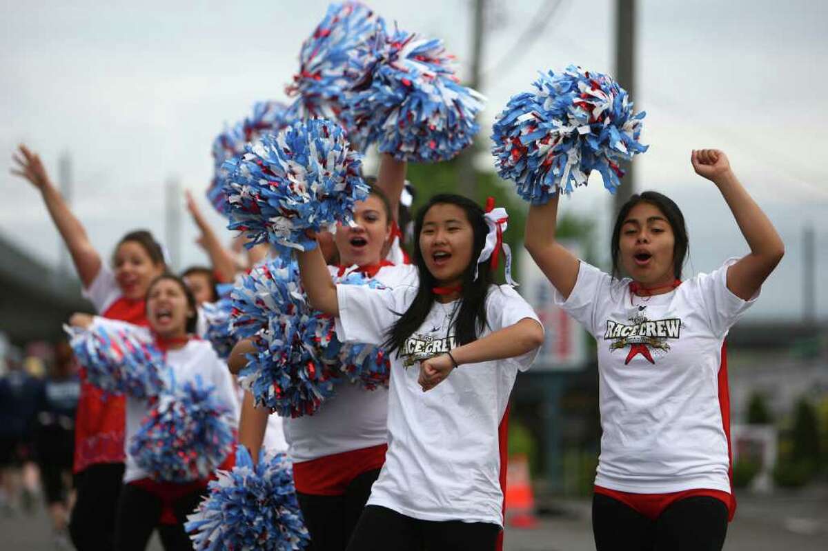 Cheerleaders from Chief Sealth High School help push runners during the Dodge Rock ‘n’ Roll Seattle Marathon & Half Marathon.