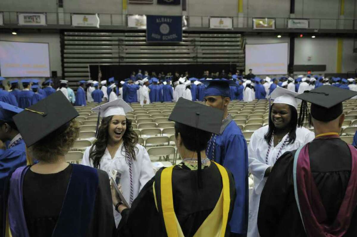 Graduates shake hands with some of their former teachers during the Albany High School commencement at the SEFCU Arena on the campus of the University at Albany. A total of 449 students graduated and close to 90% plan to attend college. (Paul Buckowski / Times Union)