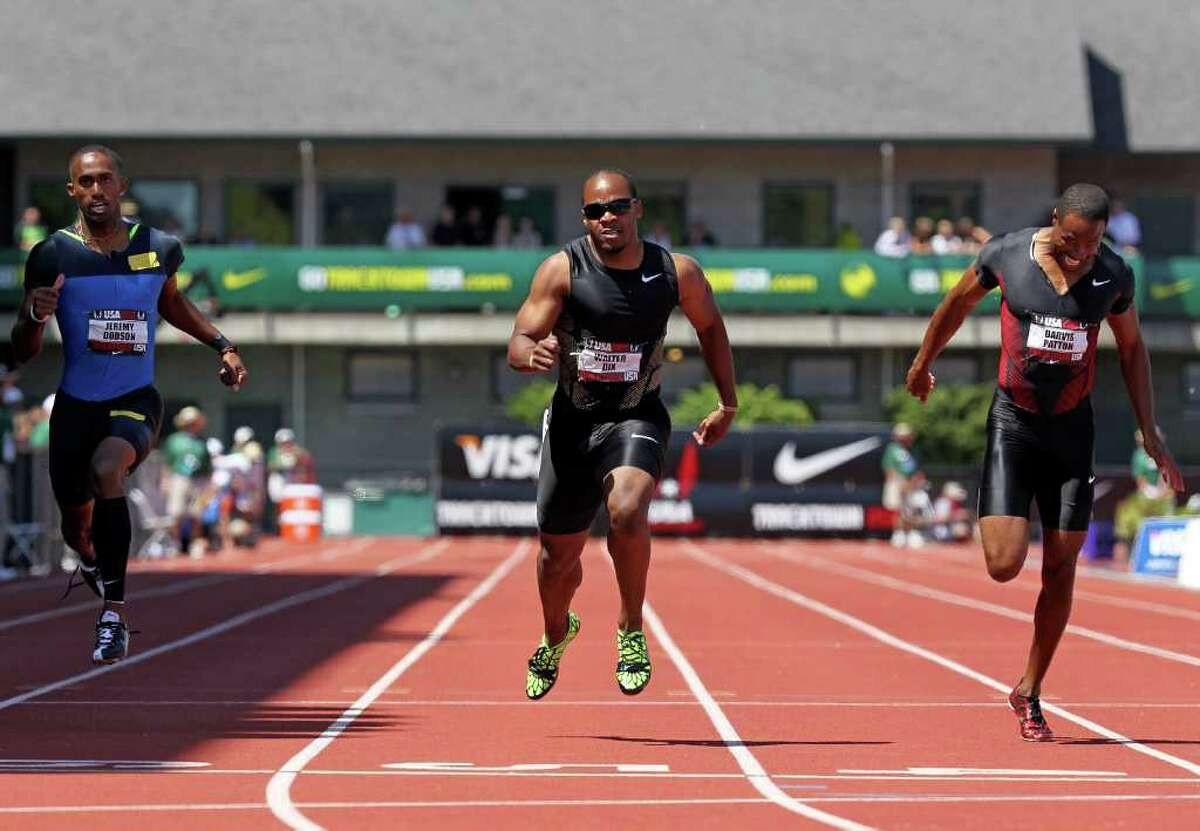 Walter Dix (center) crosses the finish line to win the men's 200 meters.
