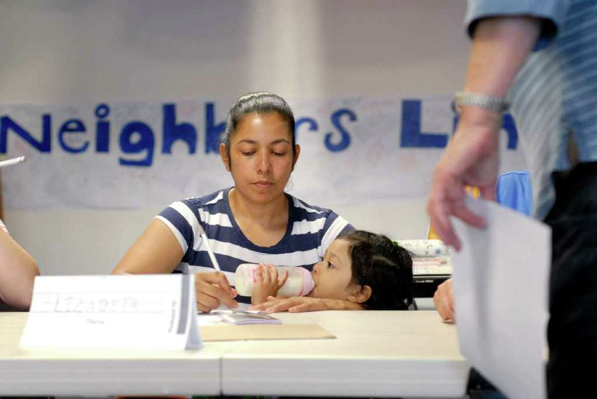 Elizabeth Palma works on her English while holding her daughter Katherine at Neighbors Link Stamford is a new non-profit organization that provides a comprehensive resource center for recent immigrants in the Stamford, Connecticut area on Monday June 27, 2011.