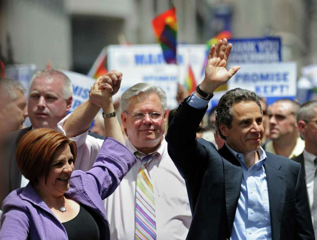 New York State Governor Andrew Cuomo (R) walks with openly gay politicians New York City Council speaker Christine Quinn (L) and New York State Senator Tom Duane (C) during the New York City gay pride march June 26, 2011. The New York state legislature voted June 24 to become the sixth state in the US to legalize same-sex marriage. AFP PHOTO/Stan HONDA
