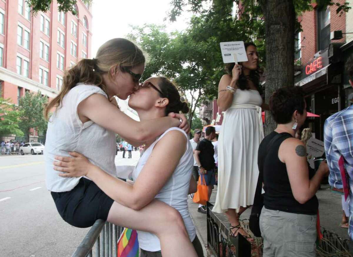 Melanie Raoul, left, and her partner Kate Woznow, share a moment after watching the Gay Pride Parade Sunday June 26, 2011 in New York. Raoul and Wosnow have been together for 8 years.