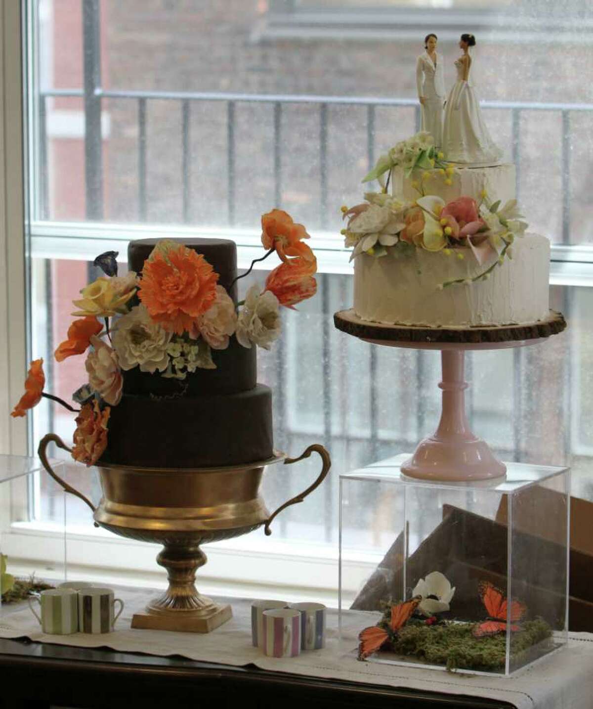 An almond cake with New York City rooftop honey buttercream icing, right, and a chocolate cake with chocolate gnash icing are on display at the Sugar Flower Cake Shop, Monday, June 27, 2011 in New York. (AP Photo/Mary Altaffer)