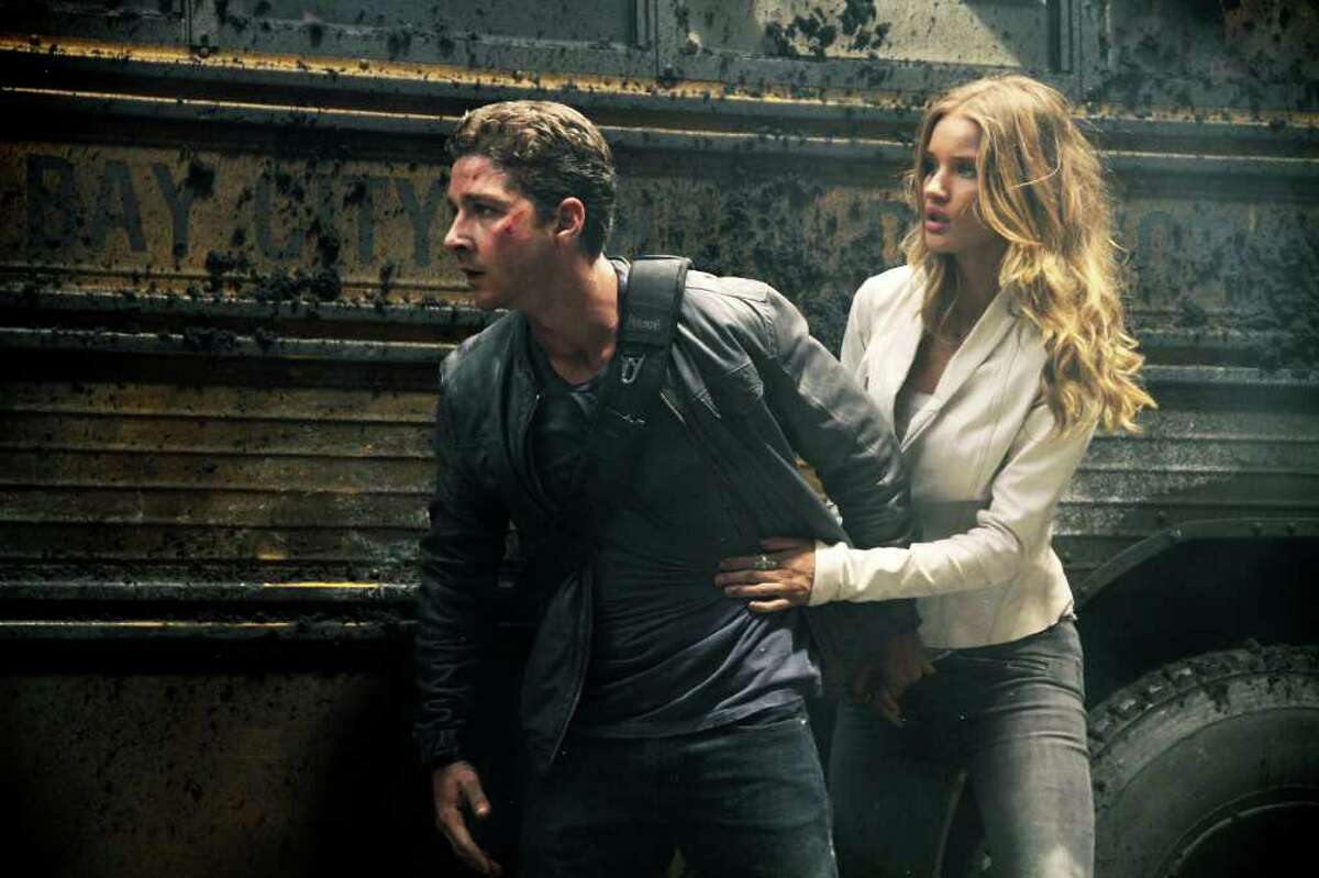 In this publicity image released by Paramount Pictures, Shia LaBeouf plays Sam Witwicky, left, and Rosie Huntington-Whiteley plays Carly in a scene from "Transformers: Dark of the Moon."