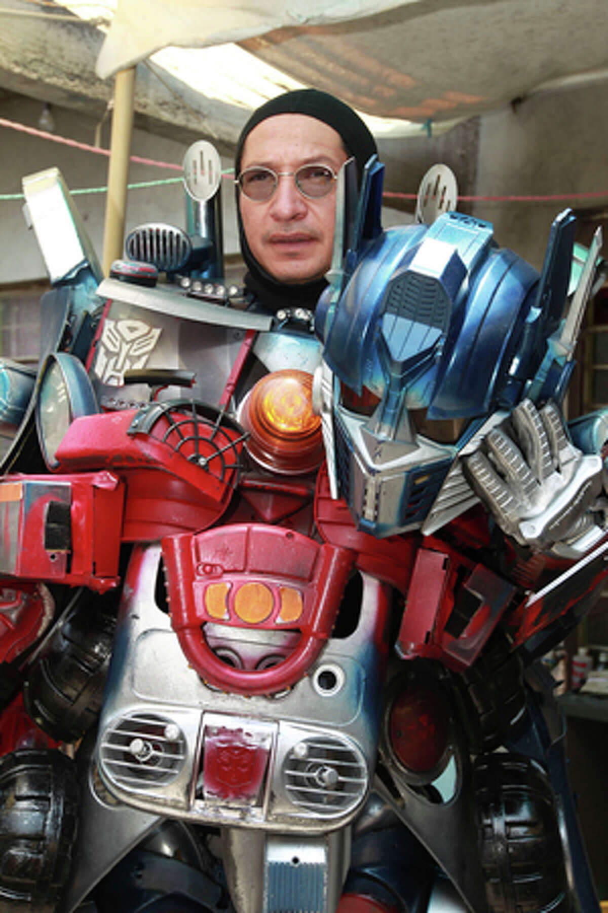 Jose Luis Mendez Luna, 38, poses wearing his Optimus Prime Transformer costume at home in a working class neighborhood in Mexico City, Wednesday, June 8, 2011. Luna whose daytime job is a plumber, is, along with his wife, both avid cosplayer and cosmakers, a type of performance art in which participants don and make costumes and accessories to represent a specific character. Their characters of choice are the Transformers and the Star Wars characters.