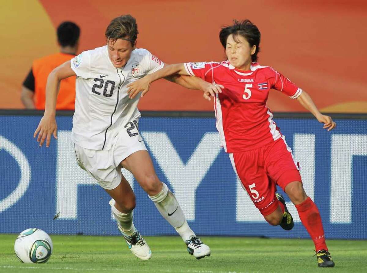 Abby Wambach of the U.S. (left) battles for the ball with Jong Sun Song of North Korea during the FIFA Women's World Cup Group C match between USA and Korea at Rudolf-Harbig-Stadion on June 28, 2011 in Dresden, Germany.