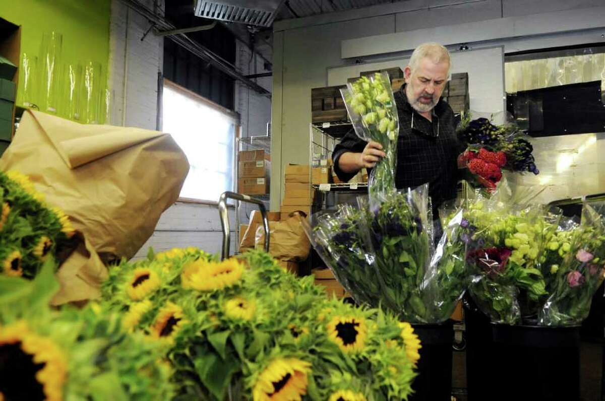 Gary Zinsmeyer, a Stamford florist and event planner, looks at flowers at East Coast Wholesale Florist in Norwalk on Tuesday, June 28, 2011. Zinsmeyer has provided flowers for a number of same-sex weddings in Connecticut.