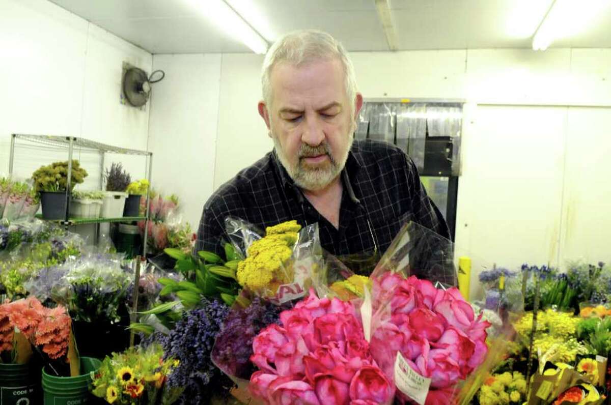 Gary Zinsmeyer, a Stamford florist and event planner, looks at flowers at East Coast Wholesale Florist in Norwalk on Tuesday, June 28, 2011. Zinsmeyer has provided flowers for a number of same-sex weddings in Connecticut.