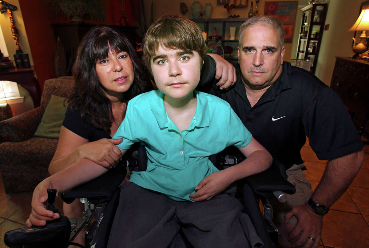 Disabled high school student Ralyn Parkhill at home with his mother Fariba Parkhill and his instructional assistant David Carnes on June 15, 2011.