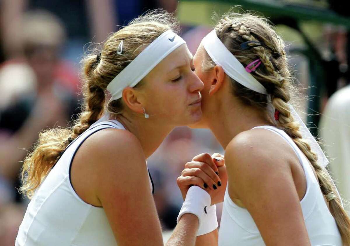 Petra Kvitova of the Czech Republic, left, shakes hands after defeating Victoria Azarenka of Belarus in their semifinal match at the All England Lawn Tennis Championships at Wimbledon, Thursday, June 30, 2011.