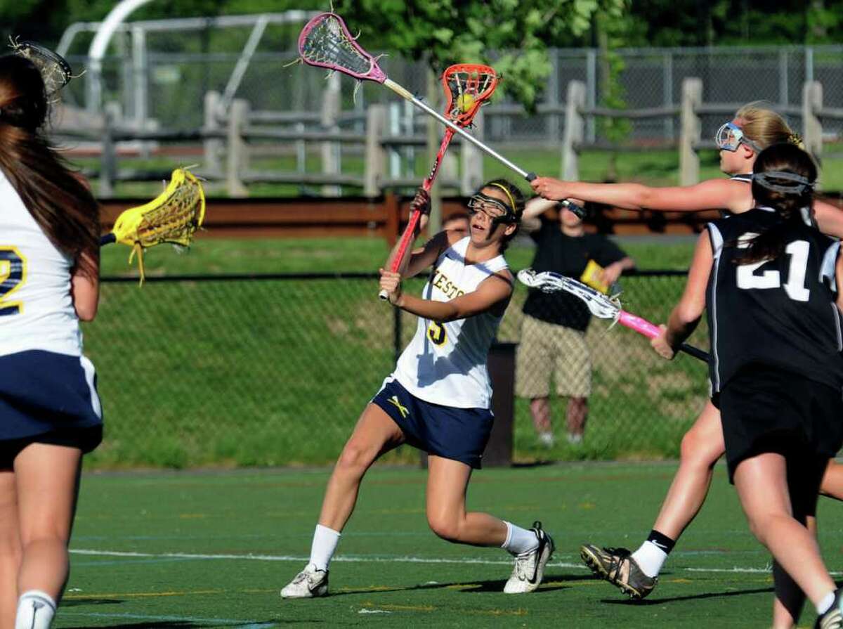 Weston's #5 Hannah Hutchins prepares to make a goal shot against Stonington, during state tournament girls lacrosse action in Weston, Conn. on Thursday June 2, 2011.