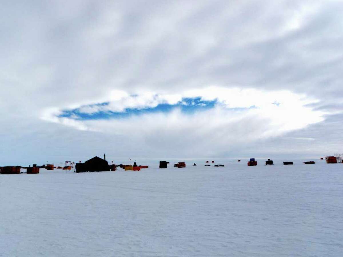 This handout photo, taken Dec. 12, 2009, provided by the journal Science shows an aircraft-induced hole observed at the West Antarctic Ice Sheet Divide Camp, Antarctica. Airplanes flying through supercooled clouds around airports can cause condensation that results in more snow and rain nearby, according to a new study. The correct conditions for this inadvertent weather modification occur about five percent of the time _ but 10-to-15 percent in winter _ according to Andrew J. Heymsfield of the National Center for Atmospheric Research in Boulder, Colo., lead author of the study appearing in Friday's edition of the journal Science. (AP Photo/ Eric Zrubek and Michael Carmody, Science)