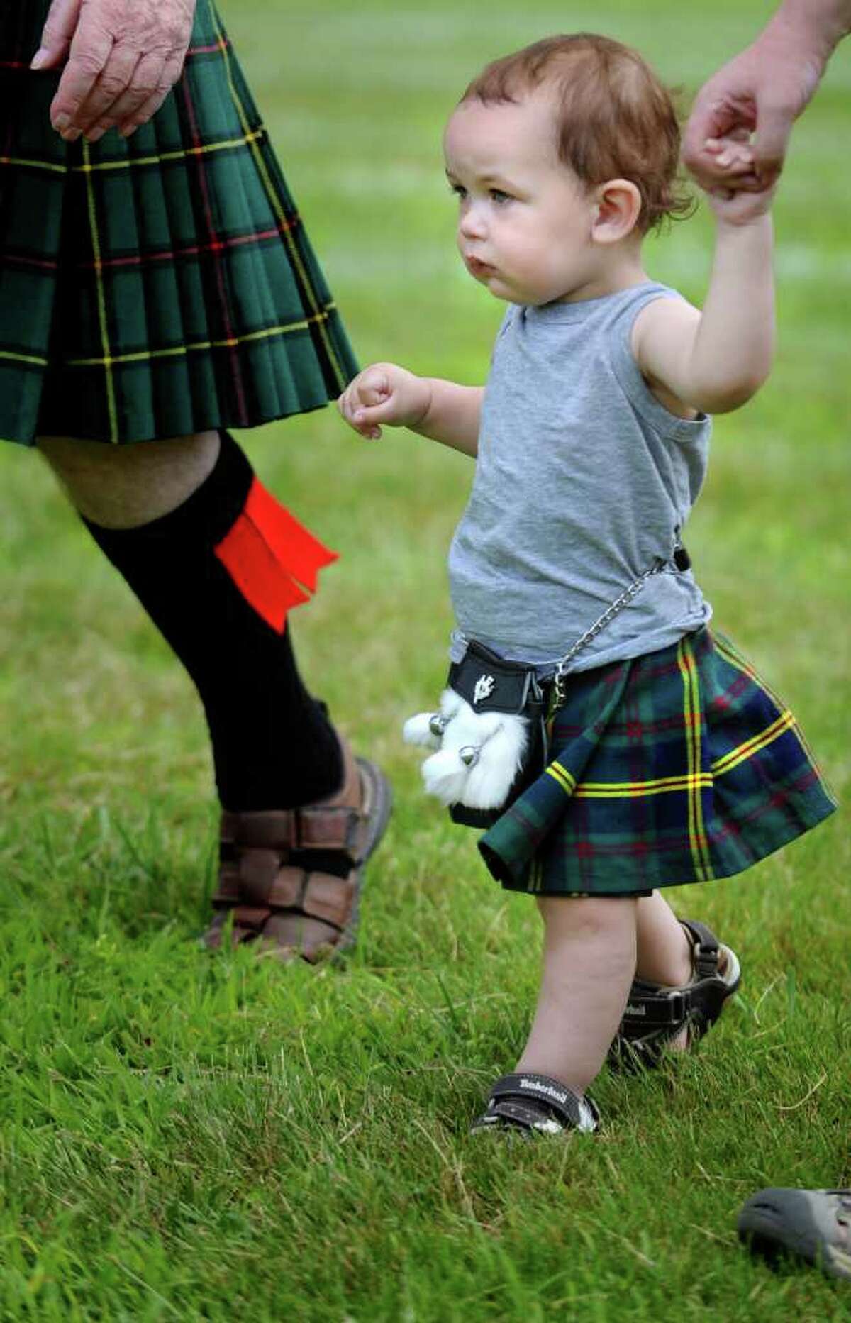 One-year-old Liam Mattice, of Trumbull, marches onto center field with clan Malcolm during opening ceremonies of the 88th Annual Round Hill Highland Games at Cranbury Park in Norwalk, Conn. Saturday, July 2, 2011.