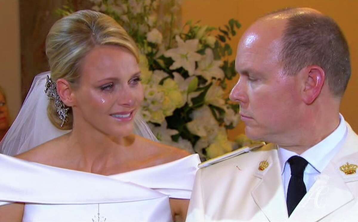 This image taken from the pool television service via Associated Press Television News shows Prince Albert II of Monaco, right, as he speaks to his new bride, Charlene Princess of Monaco with a tear on her cheek during their wedding service in the chapel of the Sainte Devote Church Saturday, July 2, 2011. (AP Photo/Television Pool via APTN) NO ARCHIVE PHOTO MAY NOT BE USED FOR MORE THAN 14 DAYS FROM SATURDAY