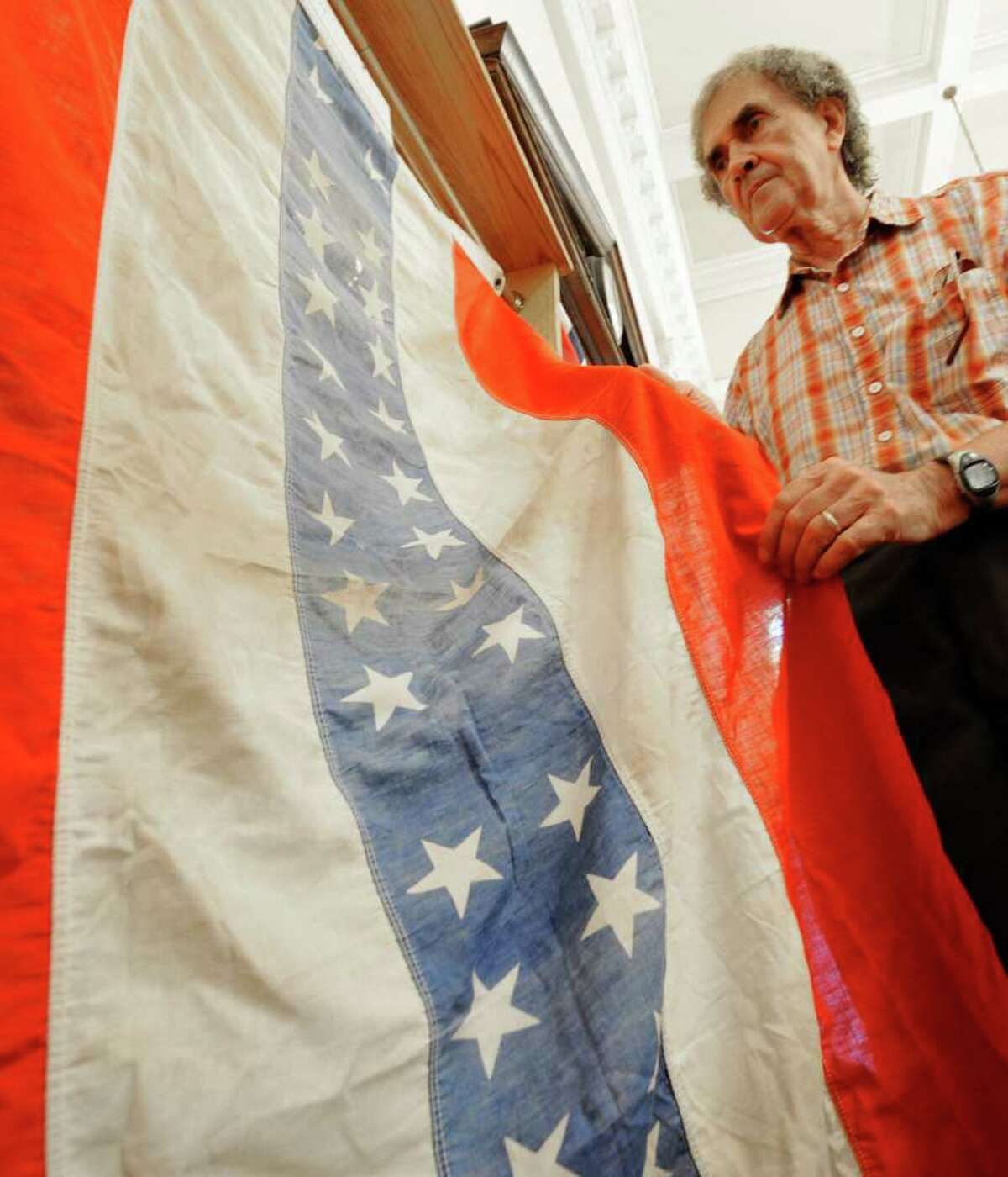 Flag collector Ron Soucy holds a 34 star banner at the Watervliet Historical Society building in Watervliet, N.Y. June 30, 2011. (Skip Dickstein / Times Union)