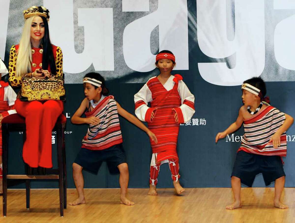 International pop diva Lady Gaga watches a group of performing indigenous Taiwanese children during a welcoming ceremony on "Lady Gaga Day" in Taichung, Taiwan, Sunday, July 3, 2011.
