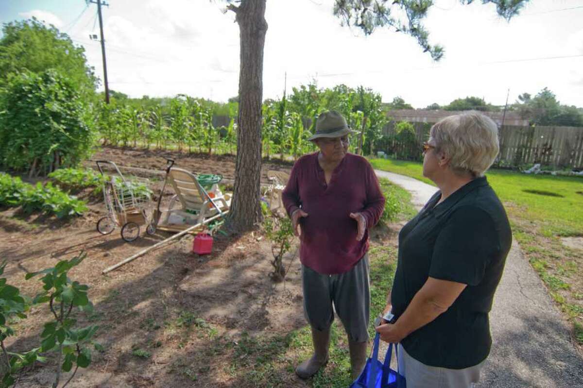 Tommy Loubon of Alief, who will assist with the Alief Community Garden, is shown with Barbara Quattro in his garden. Photo by R. Clayton McKee