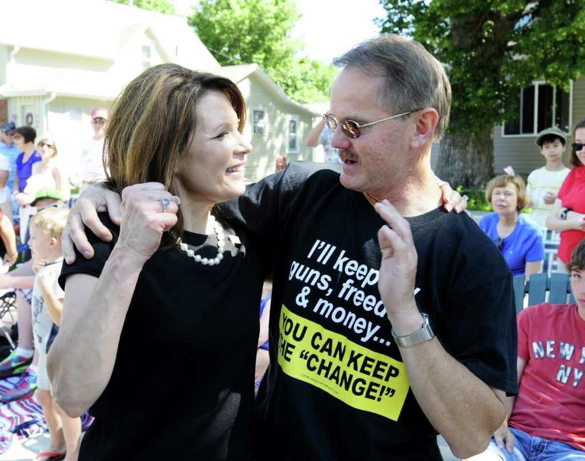 Republican presidential candidate Rep. Michele Bachmann, R-Minn., greets supporters as she marches in a Fourth of July parade July 4, 2011, in Clear Lake, Iowa.
