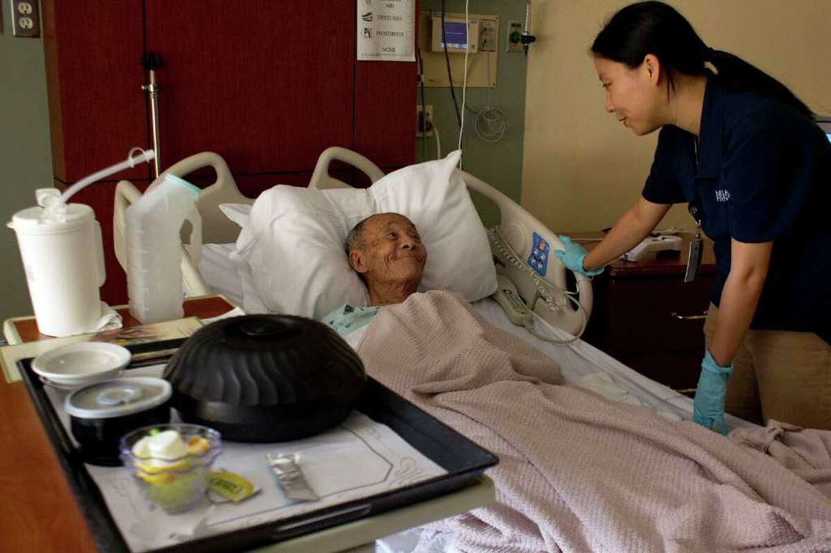 Originally from Vietnam, patient Chuong Tran, 84, smiles when talking to Vietnamese interpreter Vivi Nguyen at Memorial Hermann Southwest Hospital where he is recovering from fatigue Wednesday, June 29, 2011, in Houston. "It's pleasant," Tran said through the interpreter. "It gives me comfort to have someone speaking my language." Memorial Hermann Southwest Hospital has just renovated a 10-bed wing of the hospital to accommodate Asian patients, complete with a separate Asian menu, interpreter services, separate waiting room, Asian-based television programing and a meditation room that is currently being put together. There are more than 166,000 Asian residents in the Houston area with about 25,000 in the direct service area of Memorial Hermann Southwest Hospital. ( Johnny Hanson / Houston Chronicle )