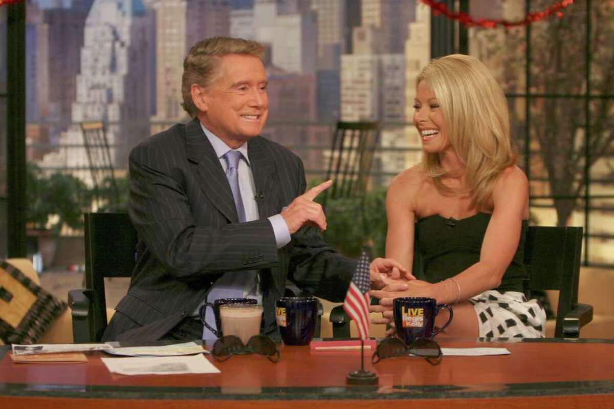 This photo supplied by Buena Vista Television shows host Regis Philbin, on his first day back on the "Live with Regis and Kelly" television show, following heart bypass surgery, talking with co-host Kelly Ripa, on the show on April 26, 2007, in New York. (AP Photo/Buena Vista Television)