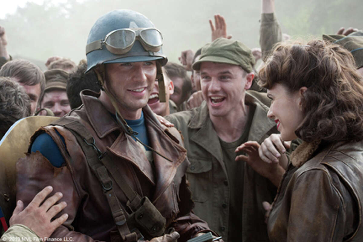 (Foreground, L-R) Chris Evans as Steve Rogers and Hayley Atwell as Peggy Carter in "Captain America: The First Avenger."