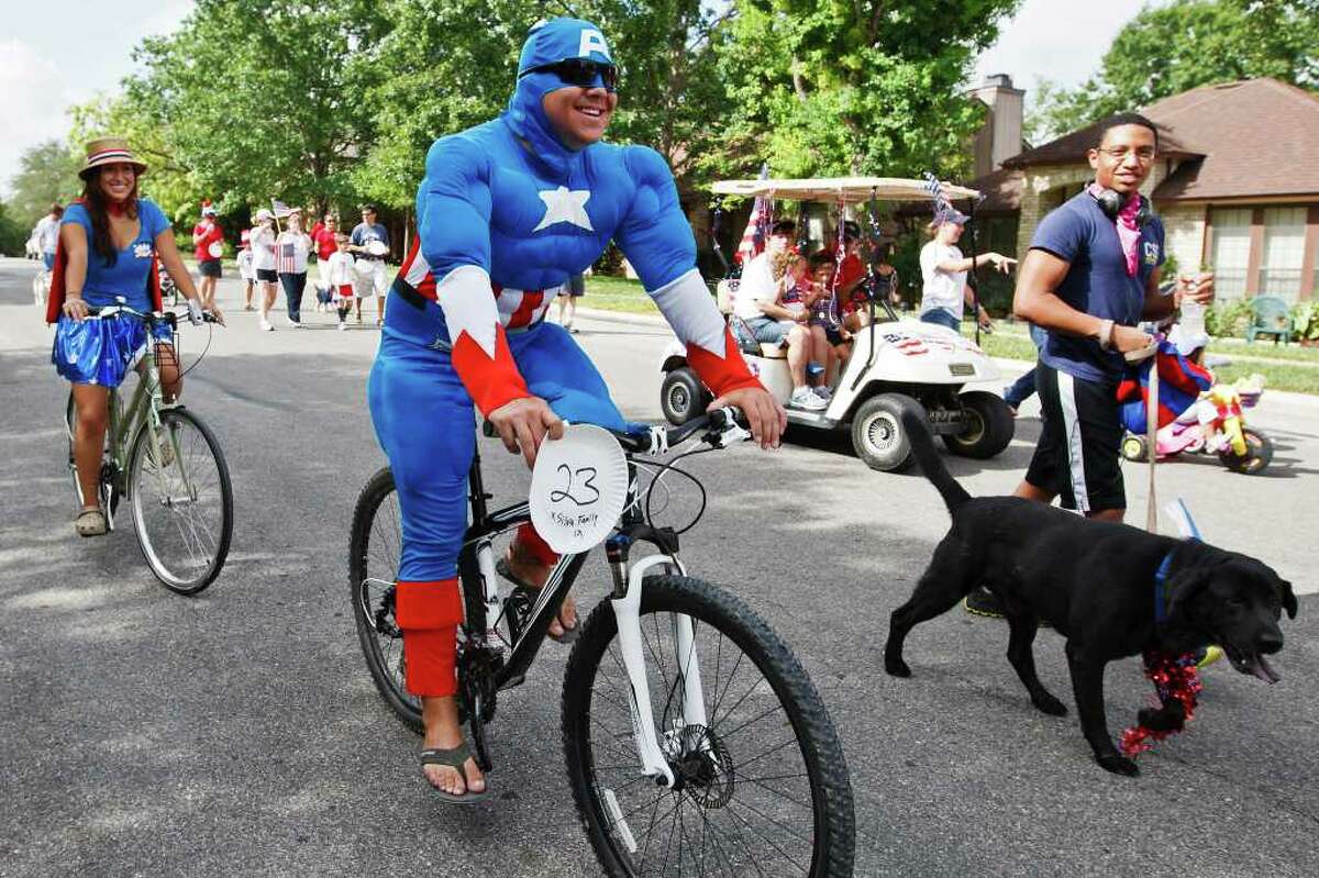 Captain America (Danny Silva) and Wonder Woman (Laura Silva) rode their bikes in the Woodridge Indepence Day celebration on July 2, 2011. Photo by Marvin Pfeiffer