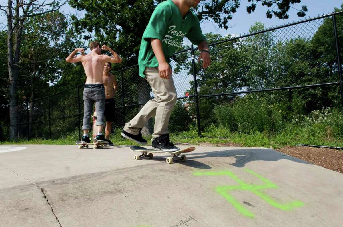 A group of teens skateboard in the skate park in Scalzi Park in Stamford, Conn. Wednesday July 6, 2011. The park was vandalized with swastikas and racist graffiti sometime in the past few weeks.
