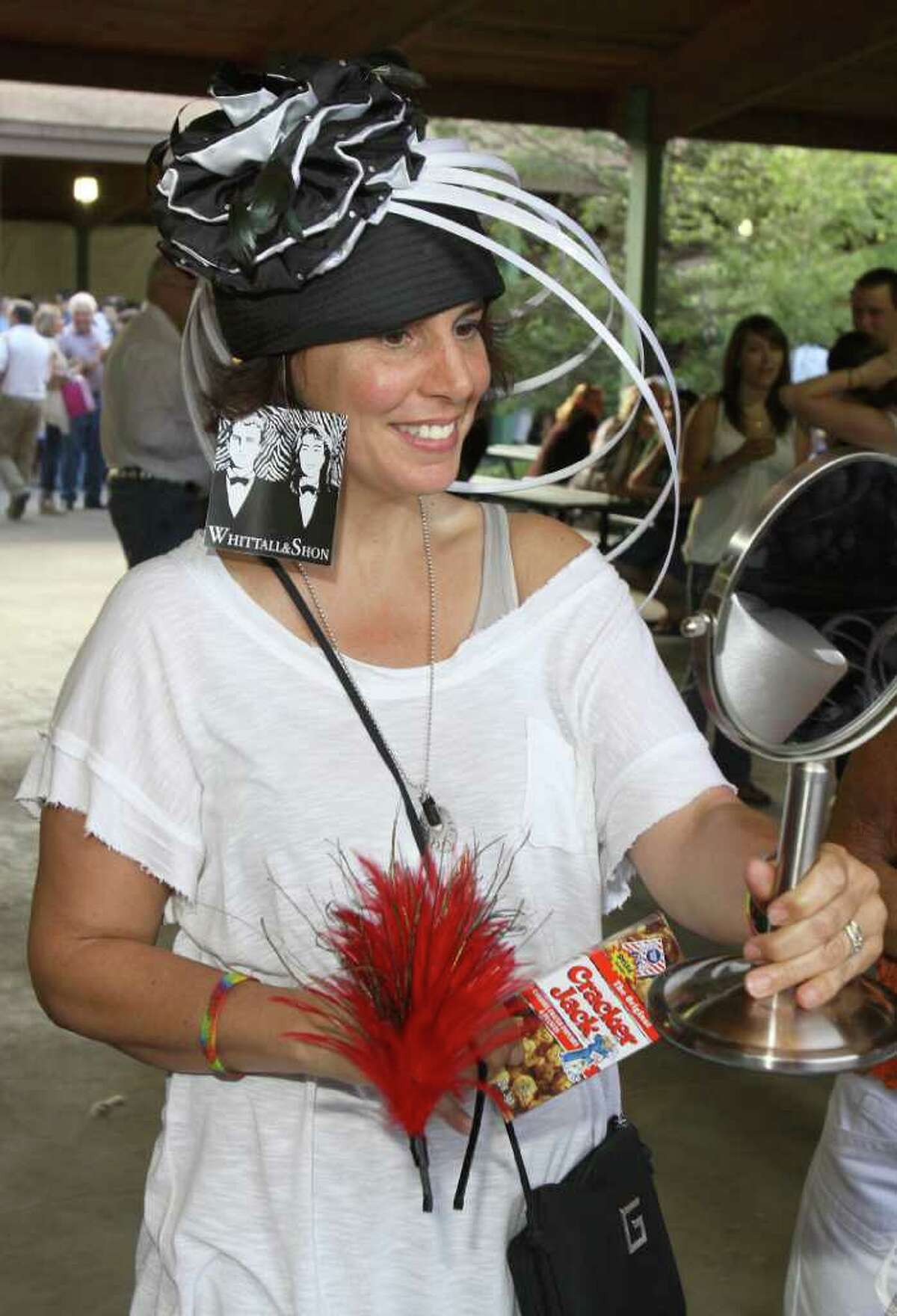 Lake George, NY - July 1, 2011 - (Photo by Joe Putrock/Special to the Times Union) - Lisa Theuer tries on a Whittall&Shon hat from the Frivolous Boutique table during the Double H Ranch 20th Anniversary Gala.
