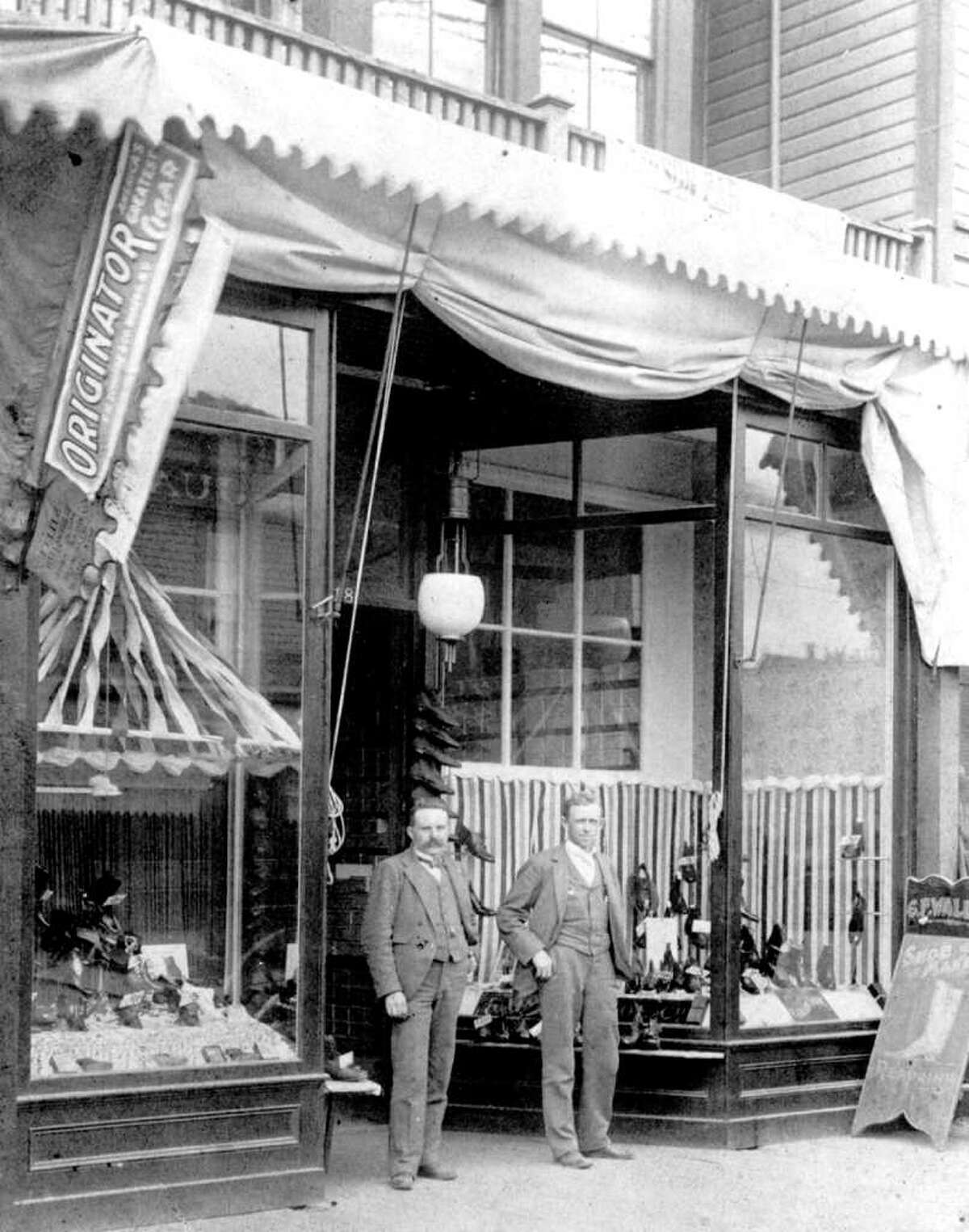 Carl Wallin, left, and John W. Nordstrom at their store near Fourth Avenue and Pike Street, 1901.