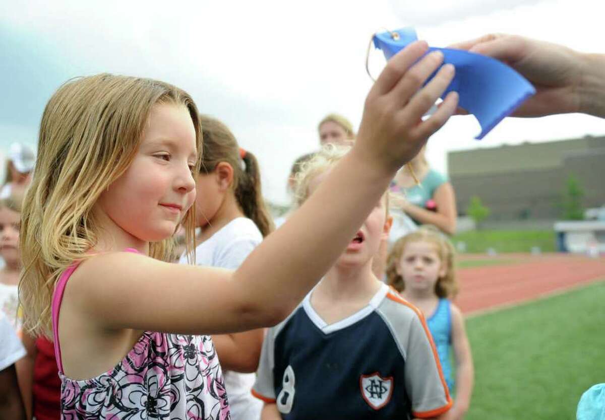 Evelyn Anvari gets a ribbon during Thursday's Westport Age Group Track Meet at Staples High School on July 7, 2011.