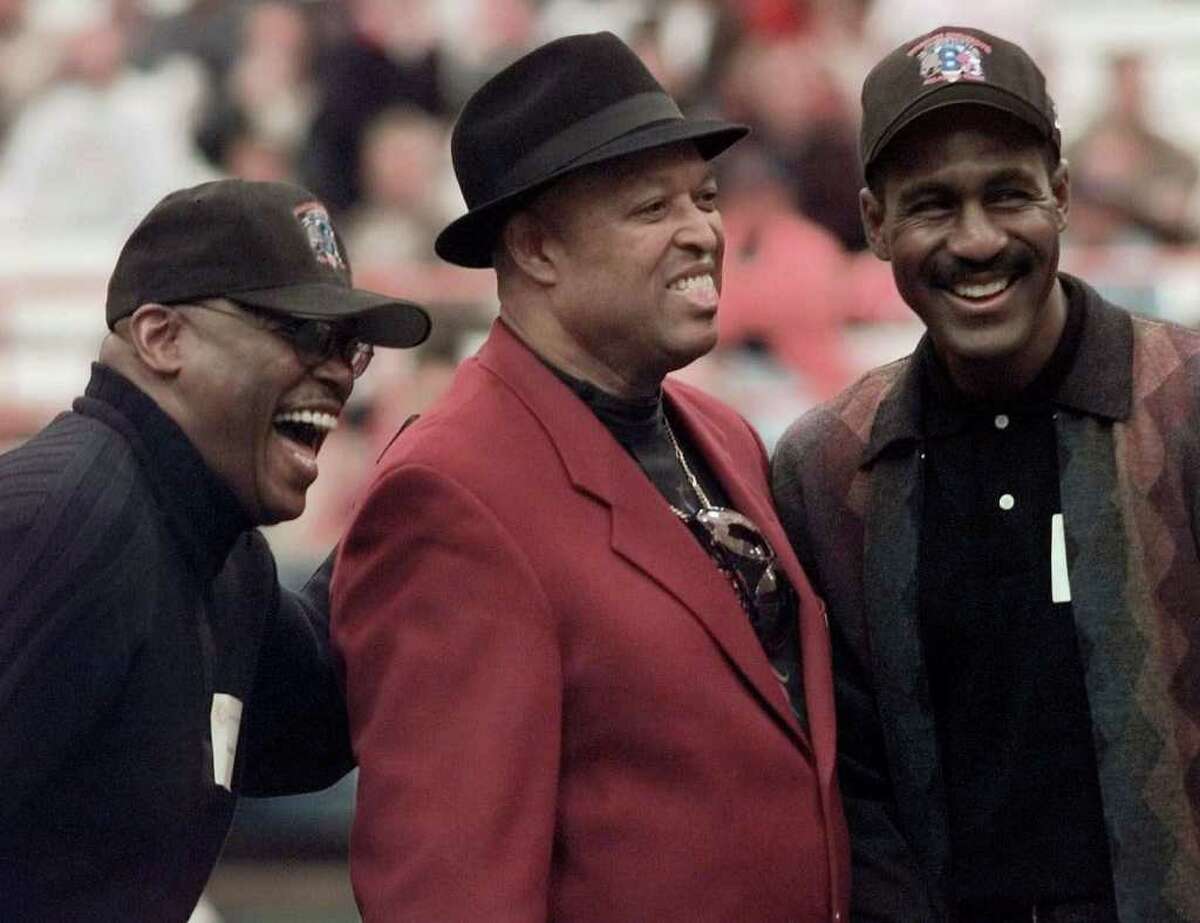 FILE - This nov. 6, 1999, file photo shows former Syracuse Orangemen greats Floyd Little, left, John Mackey, center, and Art Monk enjoying the spotlight after being introduced with other former players as part of a 44 member All-Century team, before a college football game against Temple, at the Carrier Dome in Syracuse, N.Y. NFL Hall of Famer John Mackey has died. He was 69. Chad Steele, a spokesman for the Baltimore Ravens, said Thursday, July 7, 2011, that Mackey's wife had notified the team about her husband's death.(AP Photo/Kevin Rivoli, File)
