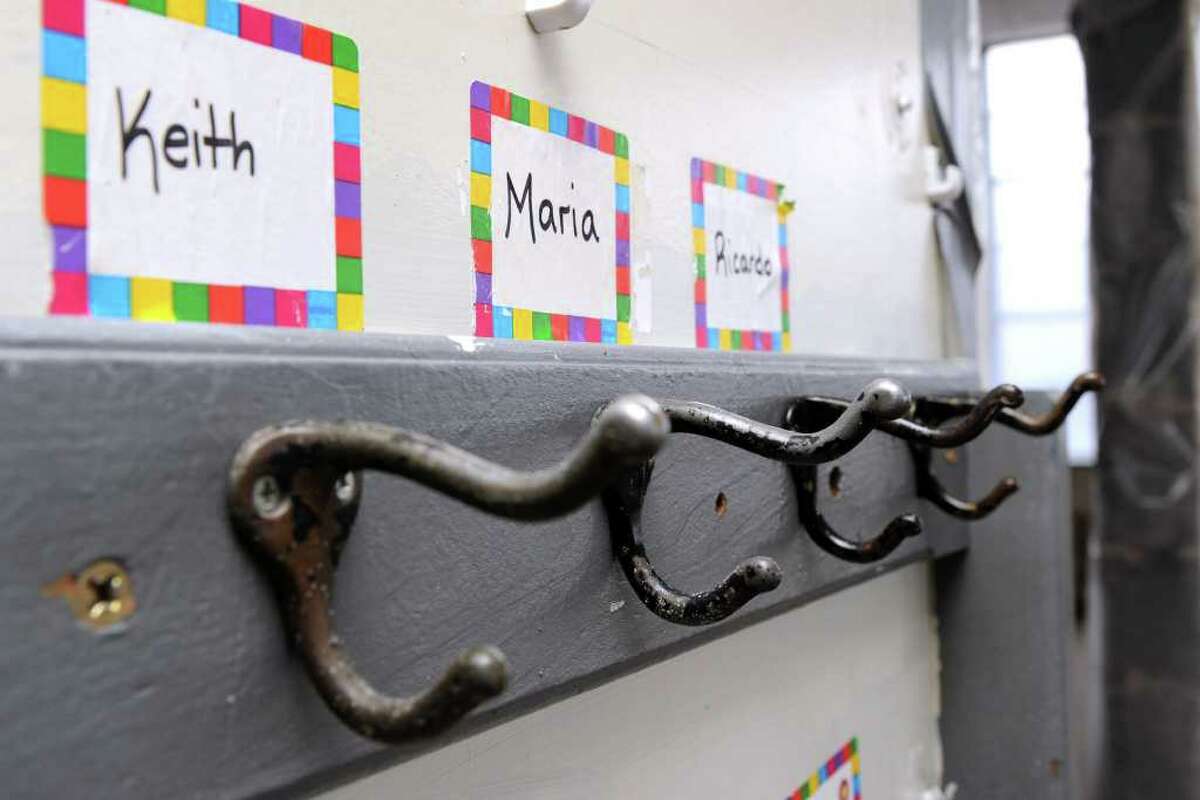 Coat hooks with the names of school children still hang on a wall at Roberts Avenue School in Danbury, which is being torn down. Photo taken Friday, July 9, 2011.