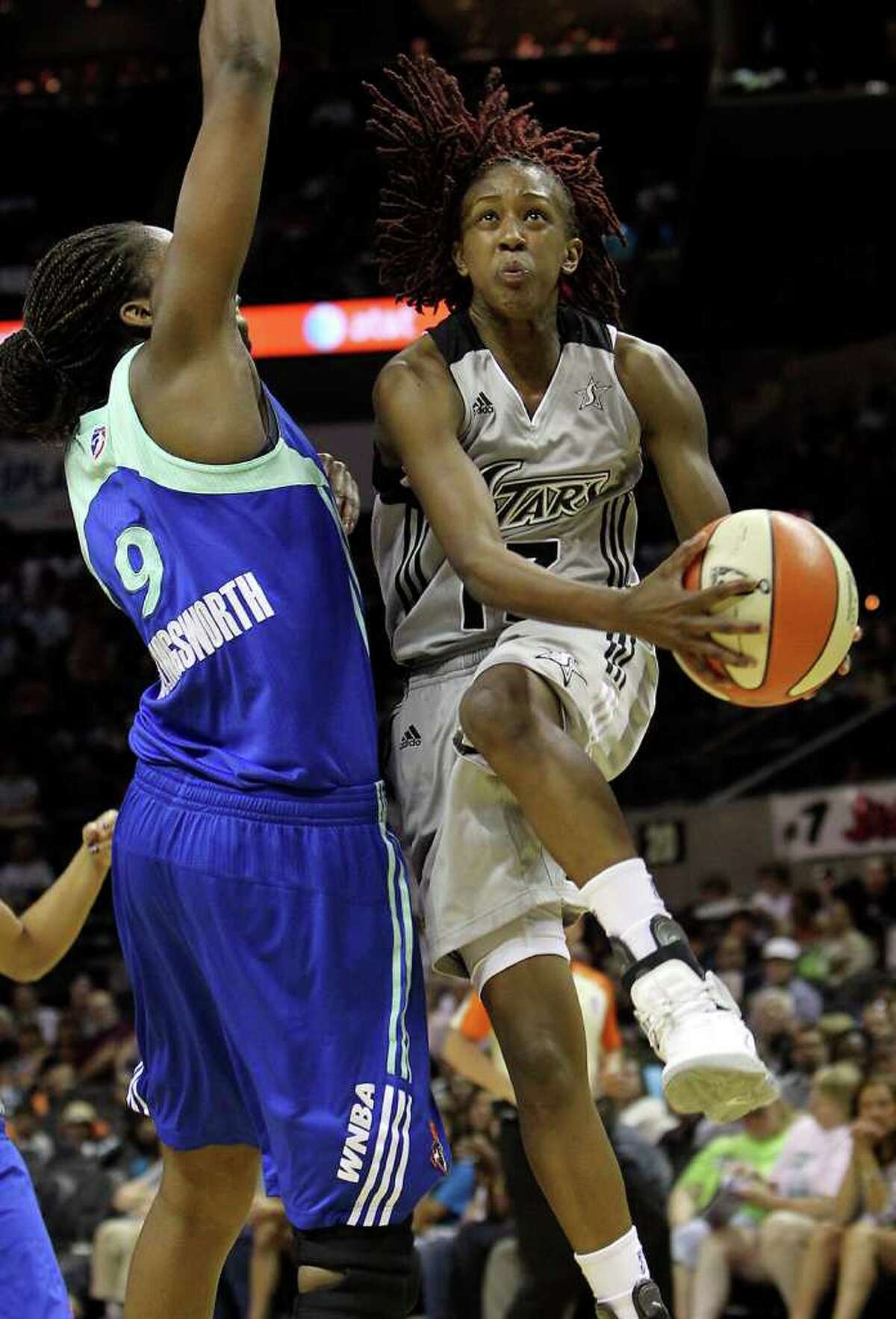Silver Stars' Danielle Robinson (13) drives to the basket against New York Liberty's Quanitra Hollingsworth (09) in the first half at the AT&T Center on Friday, July 8, 2011. Kin Man Hui/kmhui@express-news.net