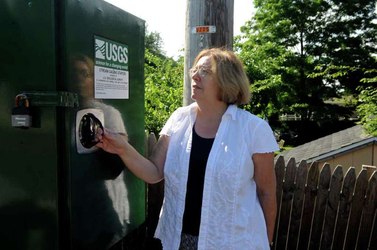 Denise Savageau, Greenwich conservation director, looks at a stream gauge on the Comley Avenue Bridge on Wednesday, June 29, 2011. Savageau is concerned about recurring droughts in Greenwich.