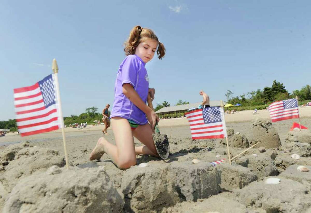 Emery Bahna, 7, of Darien, constructs her sand castle with tiny American flags during the Greenwich Arts Council's Sand Blast!, sand sculpture festival, at Greenwich Point Saturday, July 9, 2011.