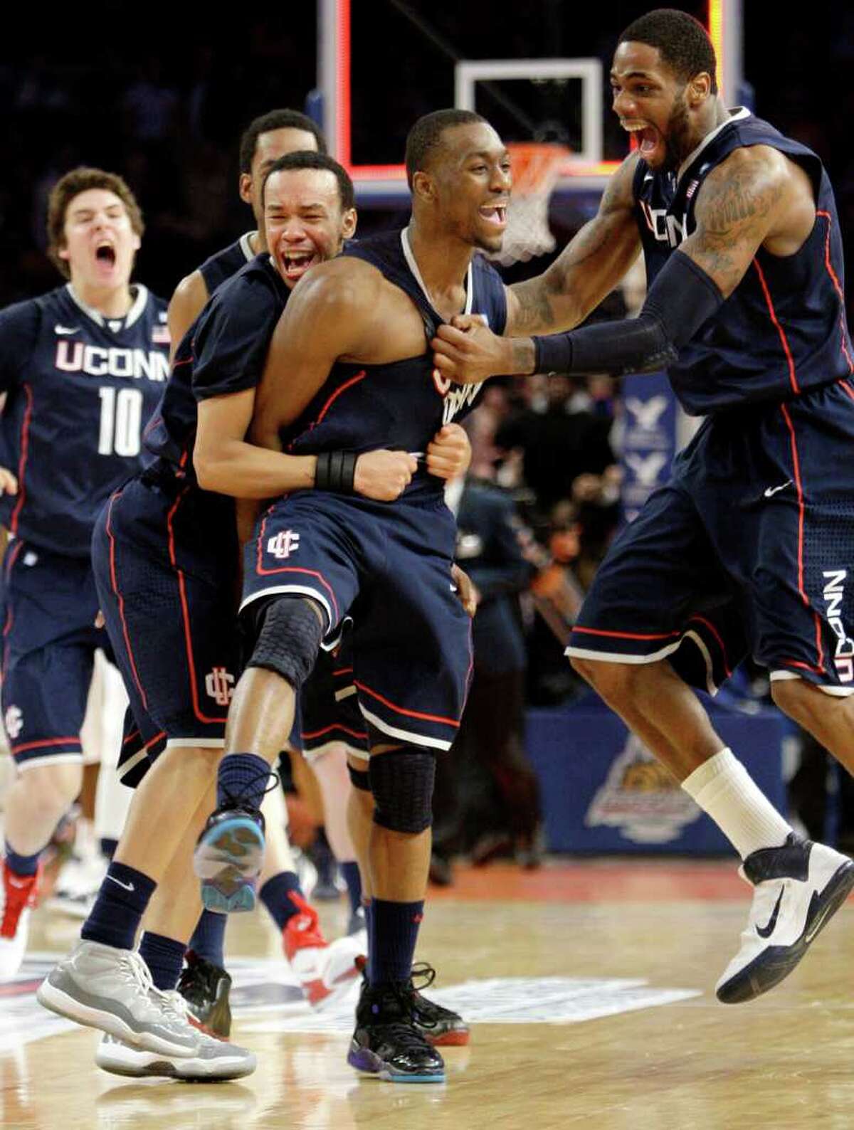 Connecticut's Kemba Walker, center, celebrates scoring the winning goal in the final seconds of the second half of an NCAA college basketball game against Pittsburgh at the Big East Championship, Thursday, March 10, 2011 at Madison Square Garden in New York. Connecticut defeated Pittsburgh 76-74. (AP Photo/Mary Altaffer)