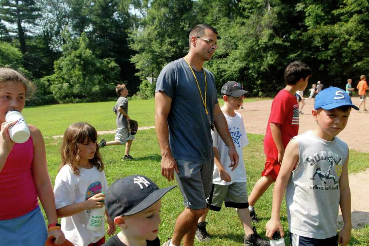 Matt Shoztic, a 5th grade teacher at Westover School, who runs a summer sports camp at Northeast School in Stamford, Conn. with Westover social worker Mitch West takes the kids for a snack break on Monday July 11, 2011.