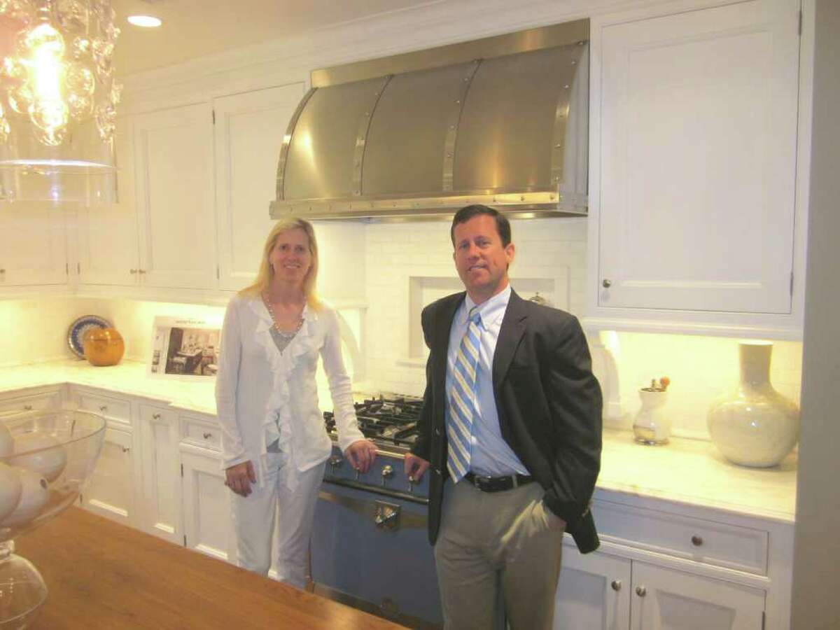 Kitchens by Deane is celebrating 50 years of doing business in New Canaan this year. In the company's Elm Street showroom is brother and sister managing team Carrie Deane Corcoran and Peter Deane. - Photo by John H. Palmer