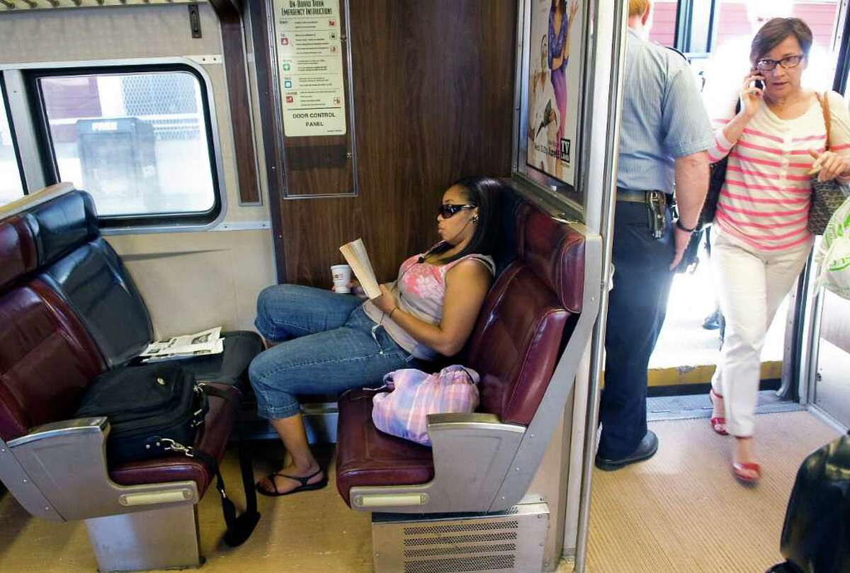 Aracelis Warren reads on the Metro-North train as passengers board while talking on cell phones en route to Grand Central Station from Greenwich, Conn. on Friday July 1, 2011. Metro-North is considering the introduction of quiet cars and is running a trial on the West of Hudson service between Pt. Jervis and Hoboken.