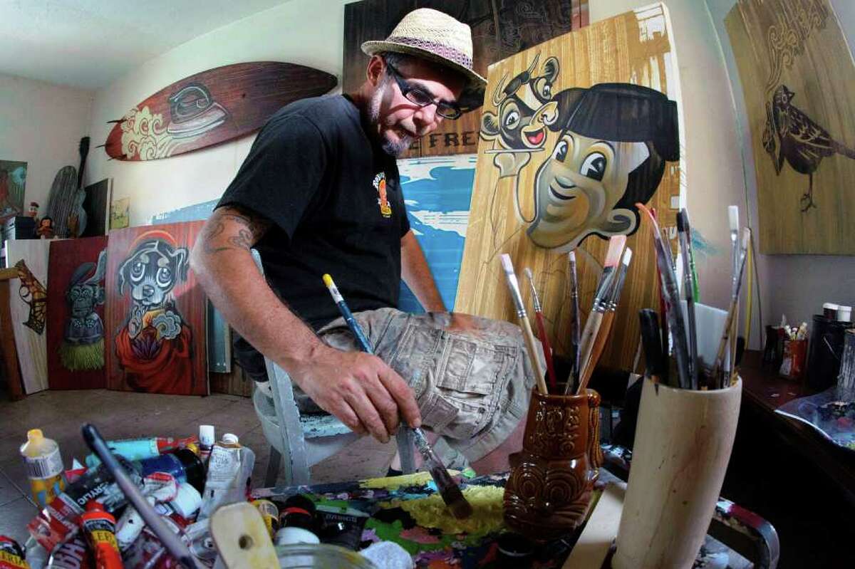 Robert Tatum works in his studio on a painting called "Bob's Big Barbacoa." The San Antonio artists frequently uses icons from the 1960s in his work.