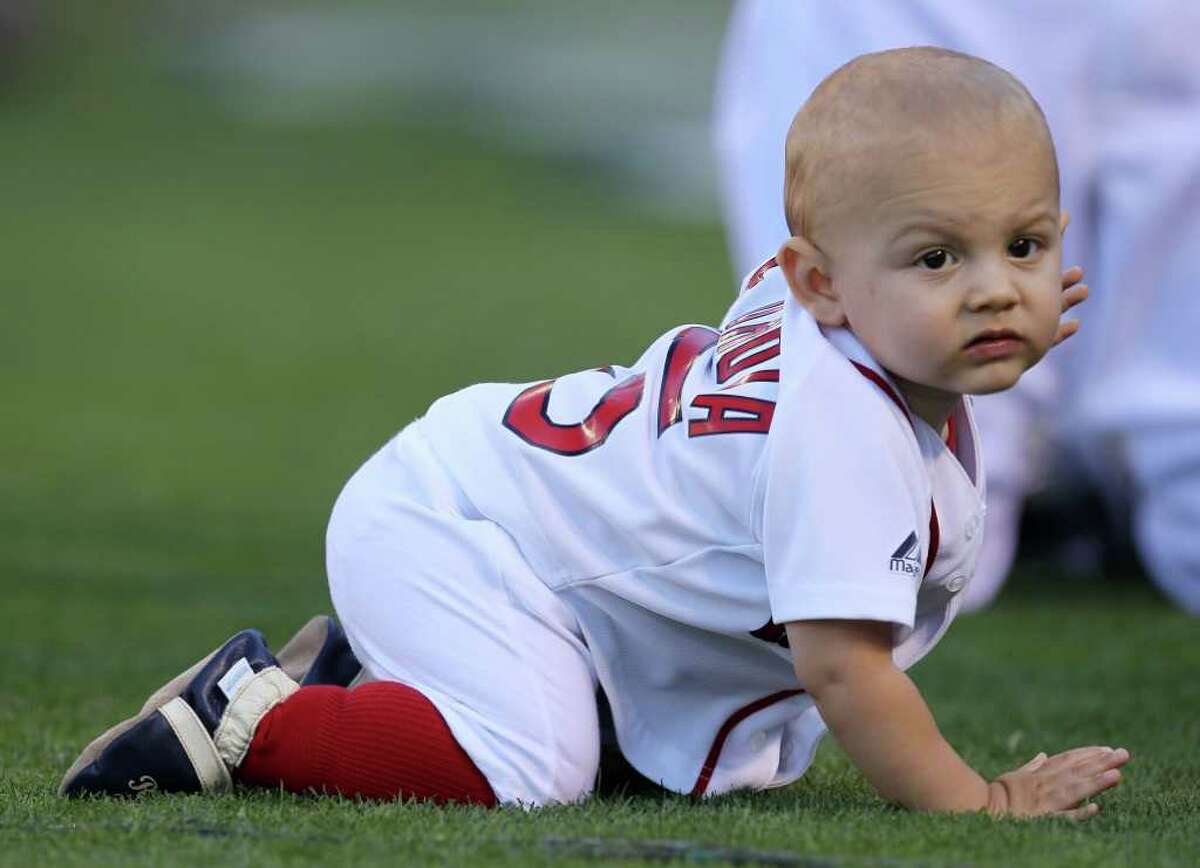 Dustin Pedroia of the Boston Red Sox with his son during the 2010