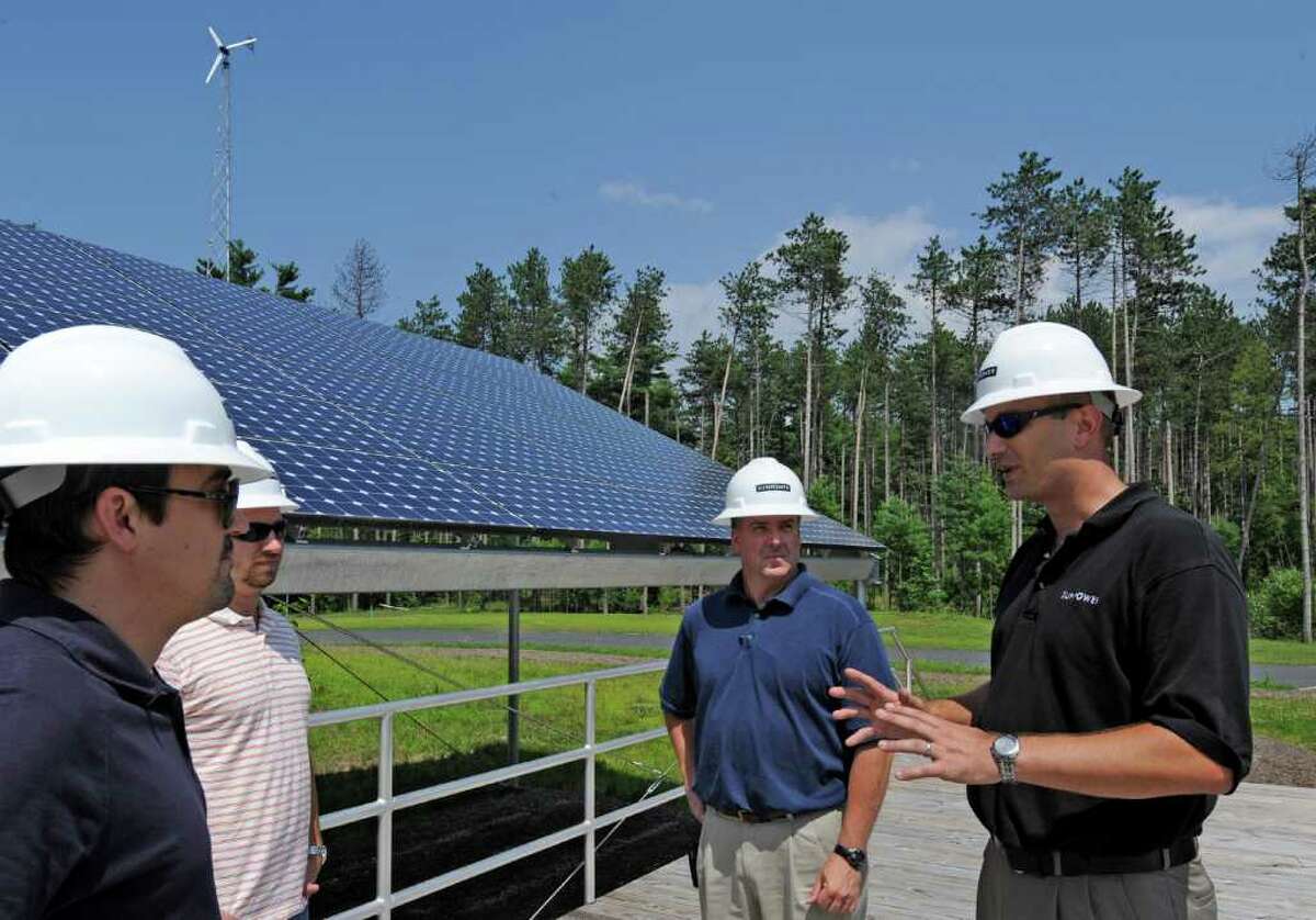 Students from various green power companies have come to the Tec Smart campus in Malta, N.Y. for training in installation of solar panels and associated equipment July 12. 2011. Under the direction of instructor/ technical trainer Isaac Opalinsky, right, Jourdan Trice of Alteris in Philadelphia, left, Jason Case of Alteris of Middletown, N.J. and Jim Carbone of ECS Energy of Jackson N.J. they receive the latest solar techniques. (Skip Dickstein / Times Union)