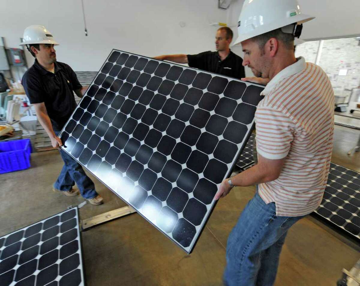 Students from various green power companies have come to the Tec Smart campus in Malta, N.Y. for training in installation of solar panels and associated equipment July 12. 2011. Under the direction of instructor/ technical trainer Isaac Opalinsky, center, Jourdan Trice of Alteris in Philadelphia, left, Jason Case of Alteris of Middletown, N.J. right, receive the latest solar techniques. (Skip Dickstein / Times Union)