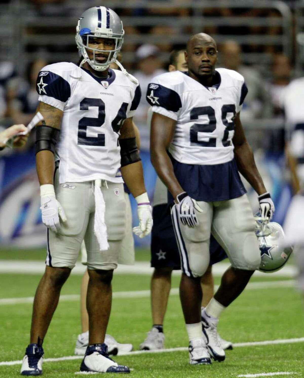 Dallas Cowboys running backs Marion Barber (24) and Felix Jones (28) attend the team's NFL football training camp in San Antonio, Friday, Aug. 7, 2009.