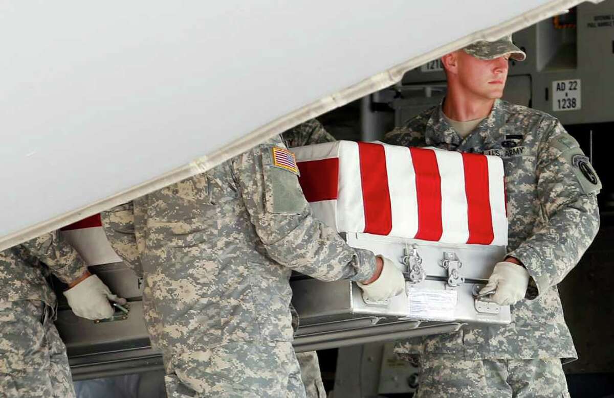 An Army carry team carries the transfer case containing the remains of Army Sgt. Steven L. Talamantez of Laredo Texas, upon arrival at Dover Air Force Base, Del. on Wednesday, July 13, 2011. The Department of Defense announced the death of Talamantez who was supporting Operation New Dawn in Iraq.